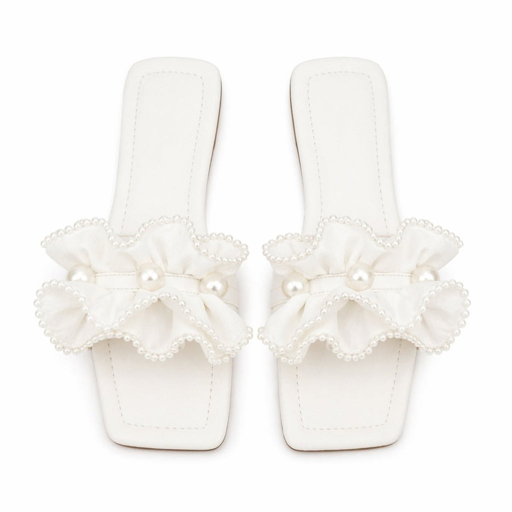 Vionnet vegan leather slides in soft beige with a minimalist design and open-toe style. 0