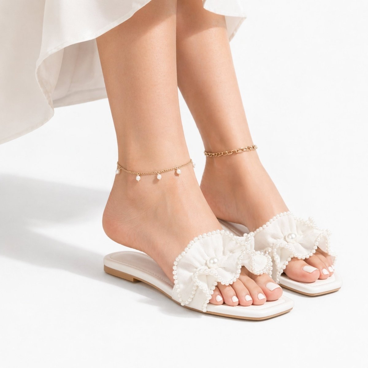 Vionnet vegan leather slides in soft beige with a minimalist design and open-toe style. 1