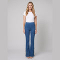 Kendra mid-wash denim flared pants with gold buttons, front