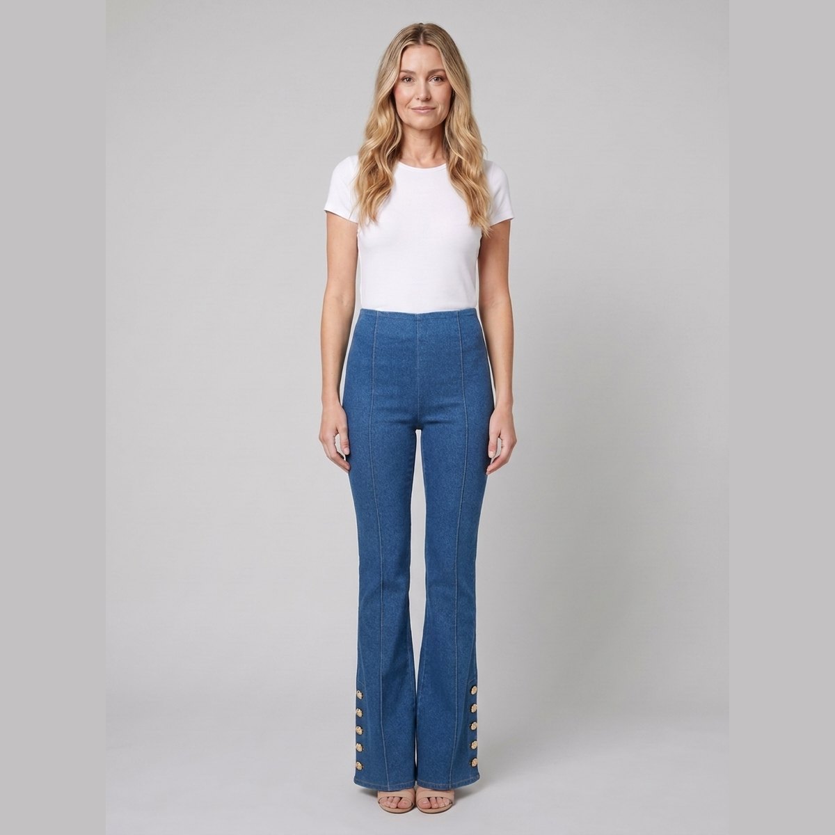 Kendra mid-wash denim flared pants with gold buttons, front