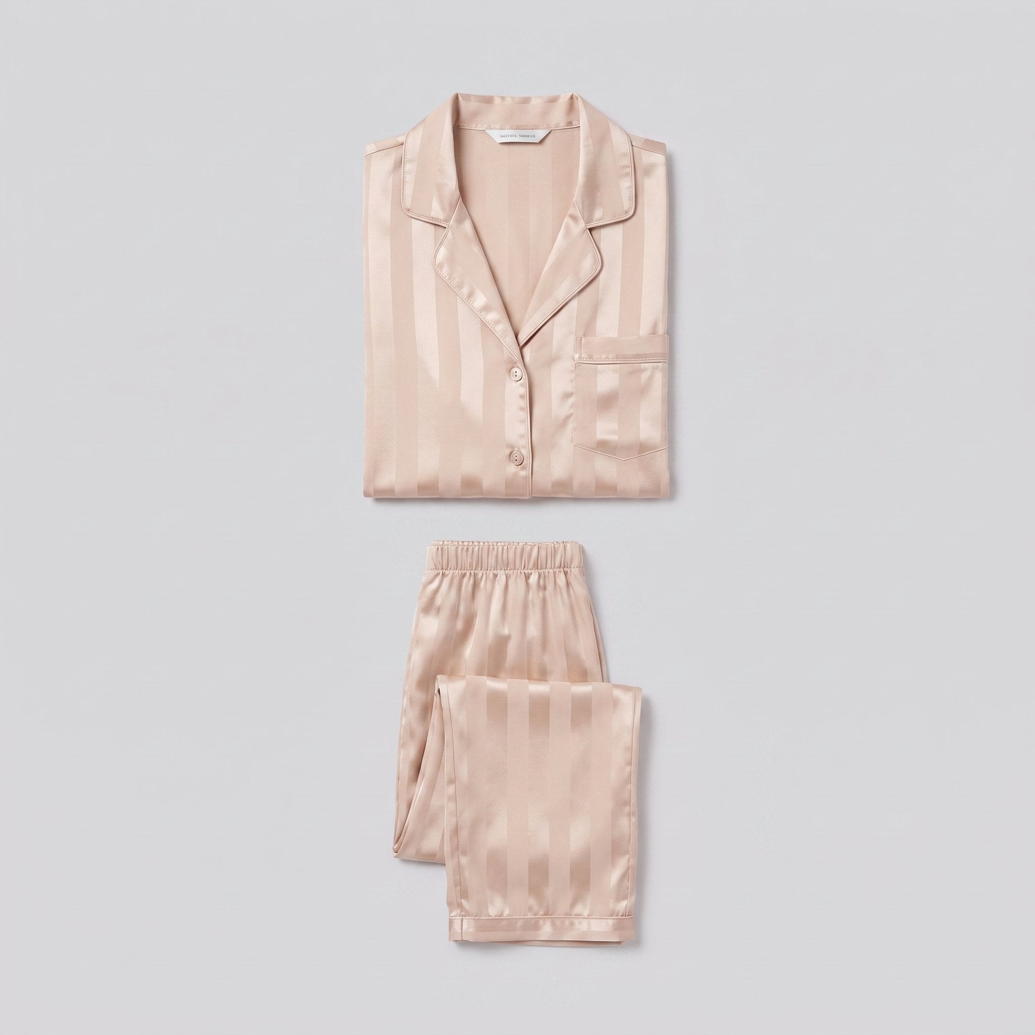 Luxe satin pyjama set in champagne beige, two-piece product flat-lay
