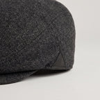 Herringbone wool weave and leather side patch close-up