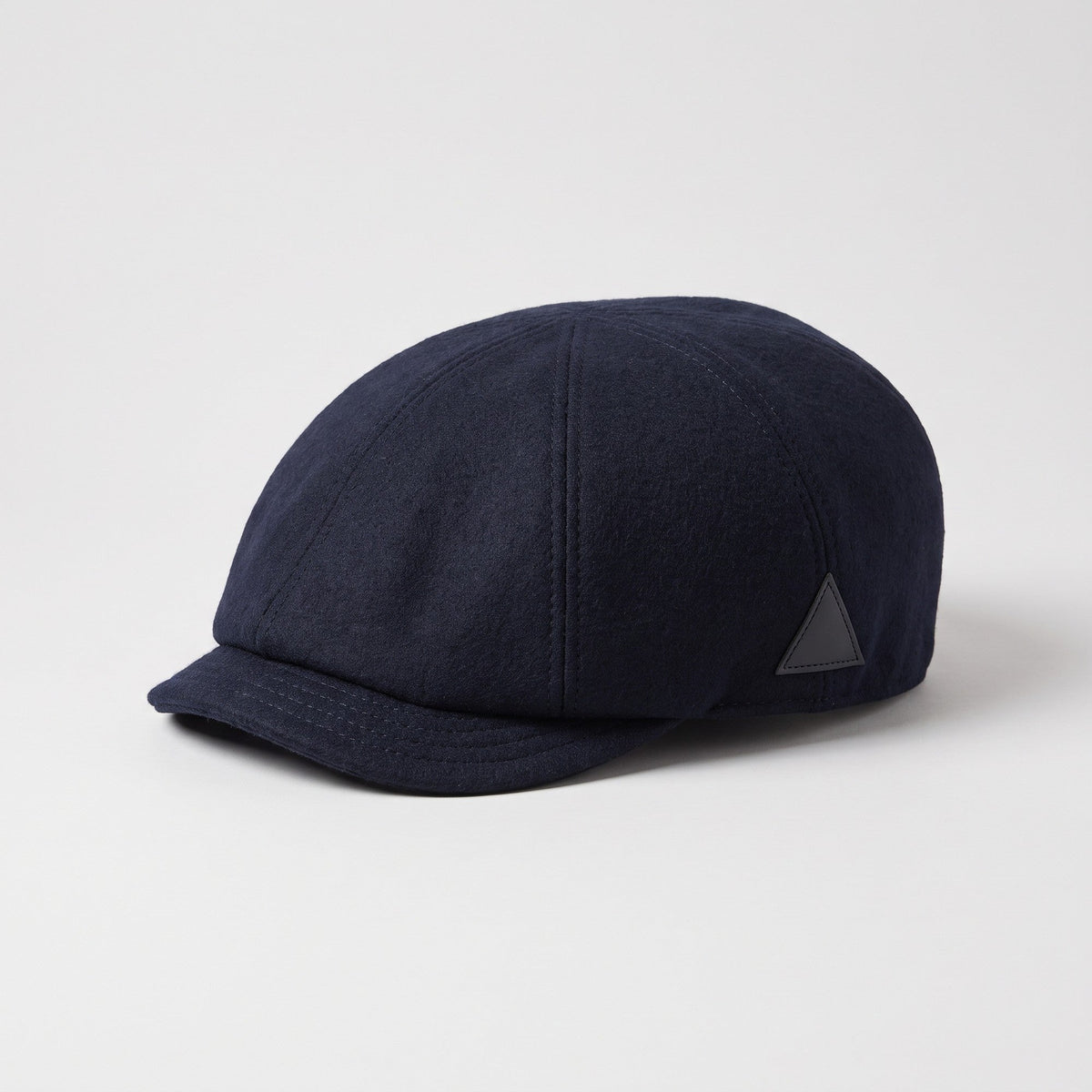 Navy blue wool flat cap, three-quarter view