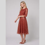 Novara | Sequin Lace Tea-Length Dress by Vera Noir – in burnt orange
